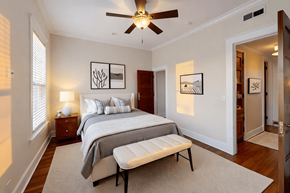 Evansville apartment for rent - A bedroom with a bed, a bench, and pictures on the wall.