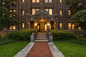 Evansville apartment for rent - A large building with a brick facade and a flag on the front.