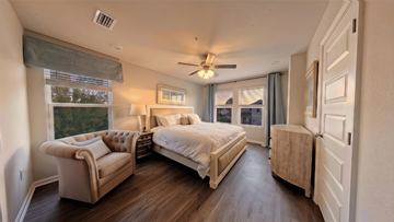 Orange Beach townhouse for rent - A bedroom with a large bed and a couch.