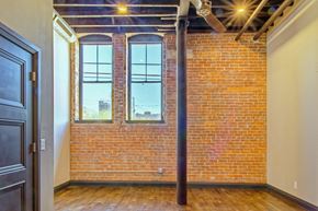 Evansville apartment for rent - A room with a brick wall and a window.