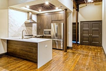 Evansville apartment for rent - A kitchen with a white island and wooden floors.