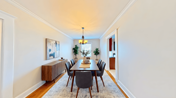 Evansville apartment for rent - A dining room with a long table and chairs.