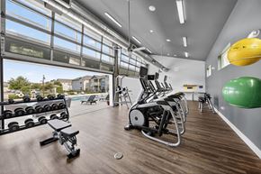 Lake Charles apartment for rent - A gym with a variety of equipment including weights, a rowing machine, and a stationary bike.