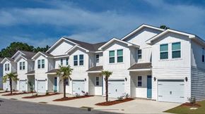 Orange Beach townhouse for rent - A row of white houses with blue doors and windows.