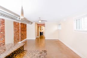 Evansville apartment for rent - A room with a brick wall and a ceiling fan.