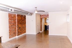 Evansville apartment for rent - A room with a brick wall and a ceiling fan.