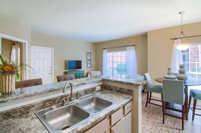 Biloxi apartment for rent - A kitchen with a sink and a dining table.