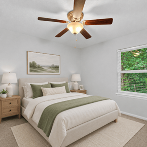 Hanahan townhouse for rent - A bedroom with a large bed and a ceiling fan.