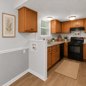 Hanahan townhouse for rent - A kitchen with wooden cabinets and a black oven.