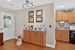 Summerville apartment for rent - A kitchen with a brown dog sitting in front of a counter at Sawbranch Apartments, Summerville, SC