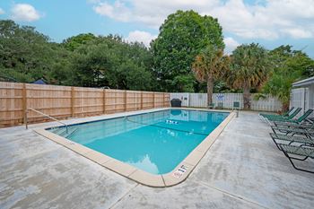 A rectangular pool with a wooden fence surrounding it.