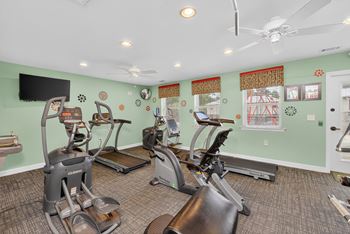 A room with exercise equipment and a television.
