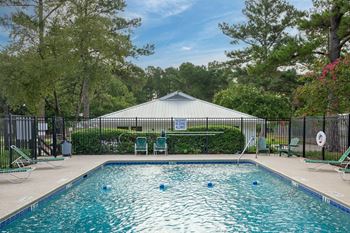 A pool with a blue sign in the background.