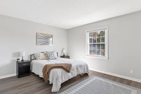 Wilmington townhouse for rent - A bedroom with a bed, nightstands, and a window at The Preserve at Pine Valley Apartments, Wilmington, NC