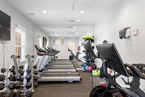 Wilmington townhouse for rent - A gym with treadmills, dumbbells, and exercise bikes at The Preserve at Pine Valley Apartments, Wilmington, North Carolina