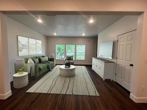 Preston townhouse for rent - A living room with a couch, a rug, and a television.