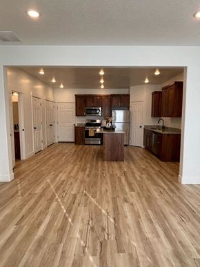 Preston townhouse for rent - A kitchen with wooden floors and cabinets.