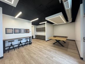 Logan apartment for rent - A room with a long table and bar stools.