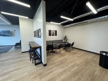 Logan apartment for rent - A conference room with a long table and chairs.