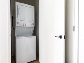 Racine apartment for rent - A white dishwasher is in a narrow space between a door and a wall.