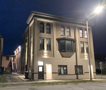 Sault Ste. Marie apartment for rent - A building with a lit-up entrance and a street lamp in front.
