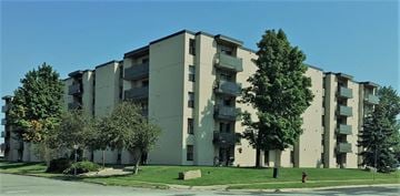 Sault Ste. Marie apartment for rent - A large apartment building with a fire hydrant in front of it.