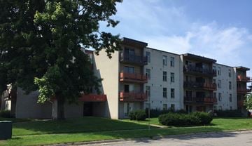 Sault Ste. Marie apartment for rent - Apartment building with balconies and greenery in front.