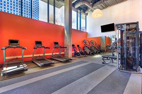 Oakland apartment for rent - A gym with treadmills, weights and a television.at Eleven Fifty Clay Street, California  