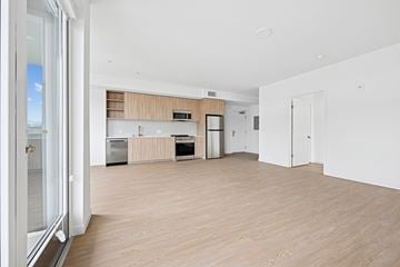 Los Angeles apartment for rent - A modern kitchen with wooden floors and white walls.