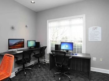 Two desks with computers and chairs