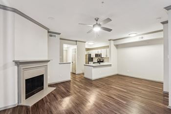 A room with a fireplace and a ceiling fan.