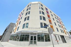 Los Angeles apartment for rent - A white building with a blue sky in the background.