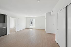 Los Angeles apartment for rent - A spacious room with wooden flooring and white walls.
