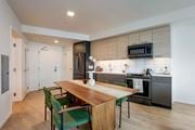 Oakland apartment for rent - A modern kitchen with a dining table and chairs.at Channel House, Oakland, 94607