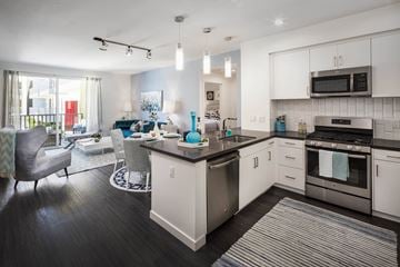Santa Monica apartment for rent - A modern kitchen with white cabinets and a black countertop.