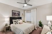 Austin apartment for rent - A bedroom with a bed, a ceiling fan, and a painting on the wall.at Onyx183, Texas, 78729