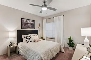 Austin apartment for rent - A bedroom with a bed, a ceiling fan, and a painting on the wall.at Onyx183, Texas, 78729