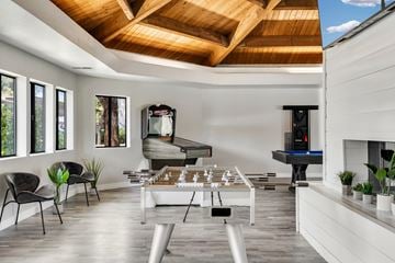 Phoenix apartment for rent - A modern living room with a pool table and a fireplace.