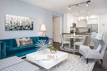 Santa Monica apartment for rent - A modern living room with a blue couch and a white coffee table.