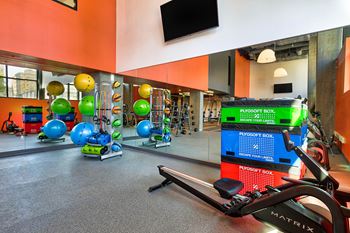 A gym with a variety of equipment including a rowing machine.