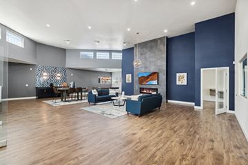 Las Vegas apartment for rent - A living room with a blue couch and a wooden floor.