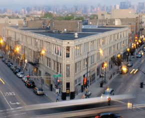 Chicago apartment for rent - A street view of a city with cars and buildings.