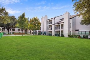 Dallas apartment for rent - A grassy area in front of apartment buildings.