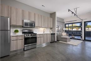 Chicago apartment for rent - A modern kitchen with a refrigerator, oven, and microwave.