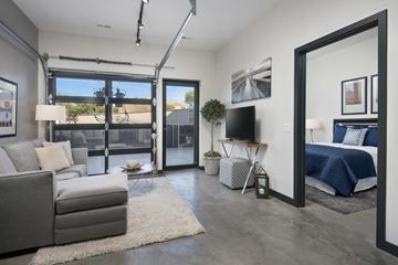 Chicago apartment for rent - A modern living room with a grey sofa and a white rug.
