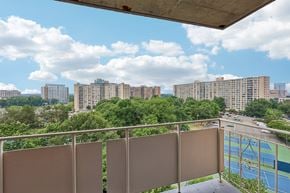 Alexandria apartment for rent - A balcony with a view of a cityscape and a pool.