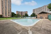 Alexandria apartment for rent - A swimming pool in a concrete pool area with buildings in the background.