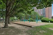 Alexandria apartment for rent - A playground with a green fence and a sandbox.
