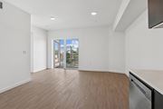 Los Angeles apartment for rent - A large empty room with a stainless steel dishwasher and wooden flooring.