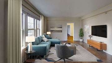 Brookline apartment for rent - a living room with a blue couch and a tv
